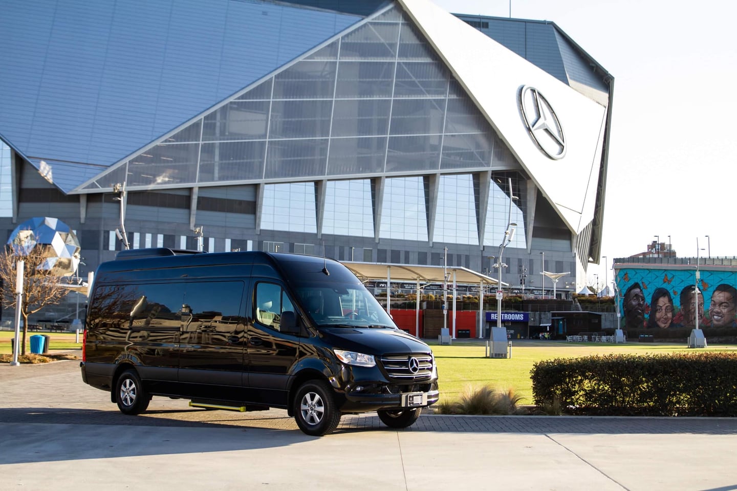 Black Label Rentals Sprinter van parked in front of Mercedes-Benz Stadium in Atlanta