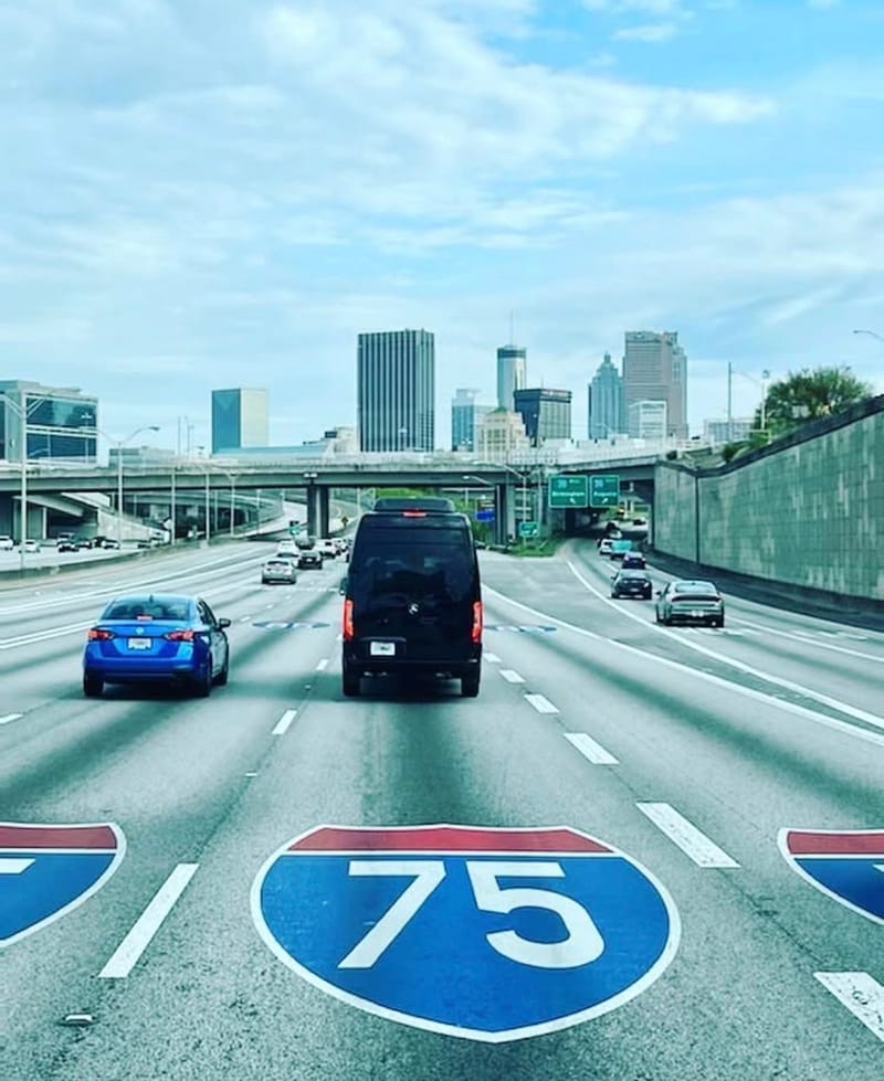 The Sprinter driving I-75 with the Atlanta skyline ahead