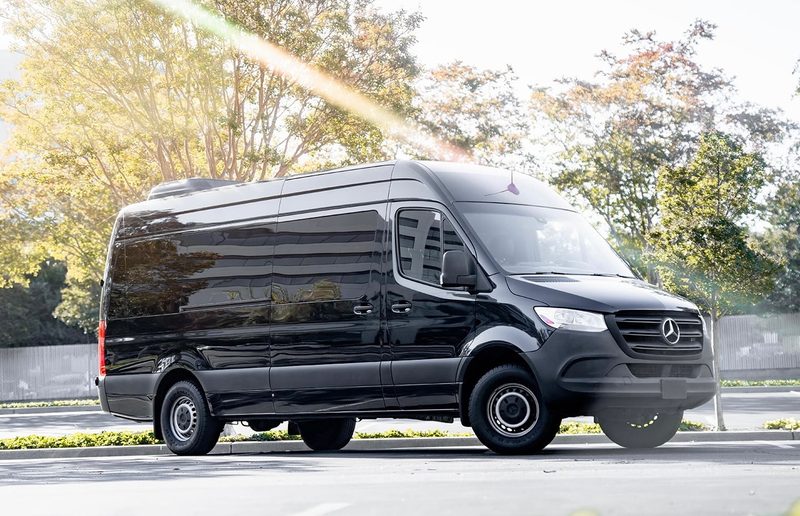 Front three quarter view of CE3, a black high roof Mercedes-Benz Sprinter, parked outdoors