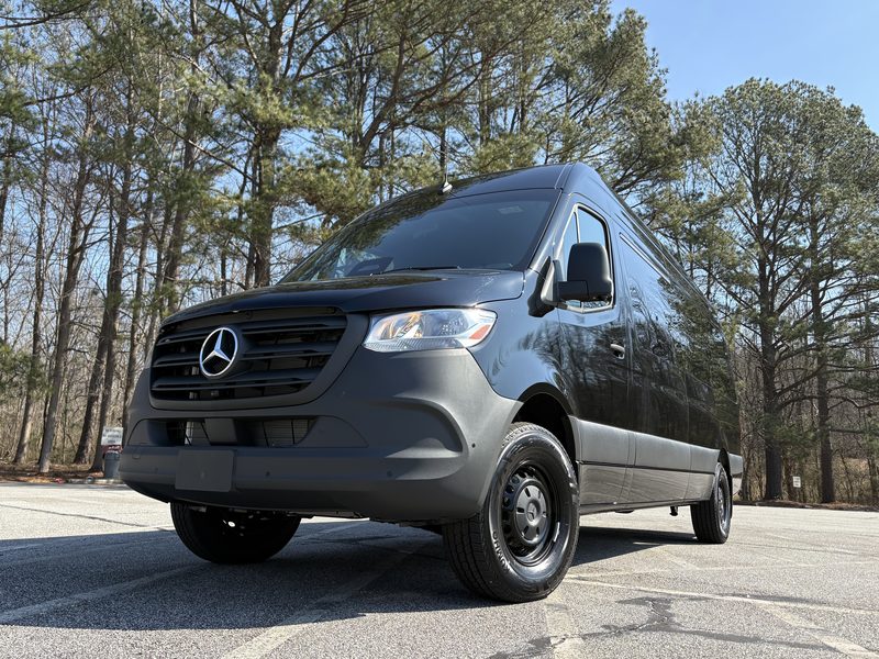 Front three quarter view of CE7, a black Mercedes-Benz Sprinter